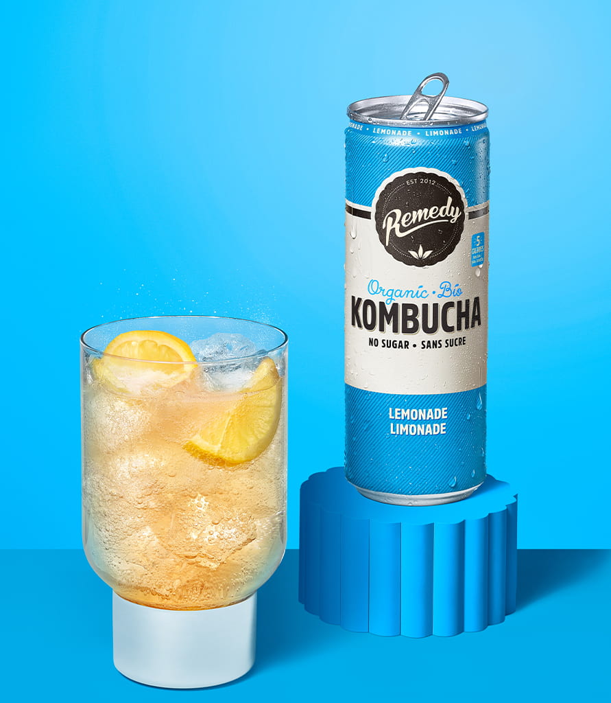 Remedy Lemonade Kombucha Can with Glass full of Kombucha Lifestyle