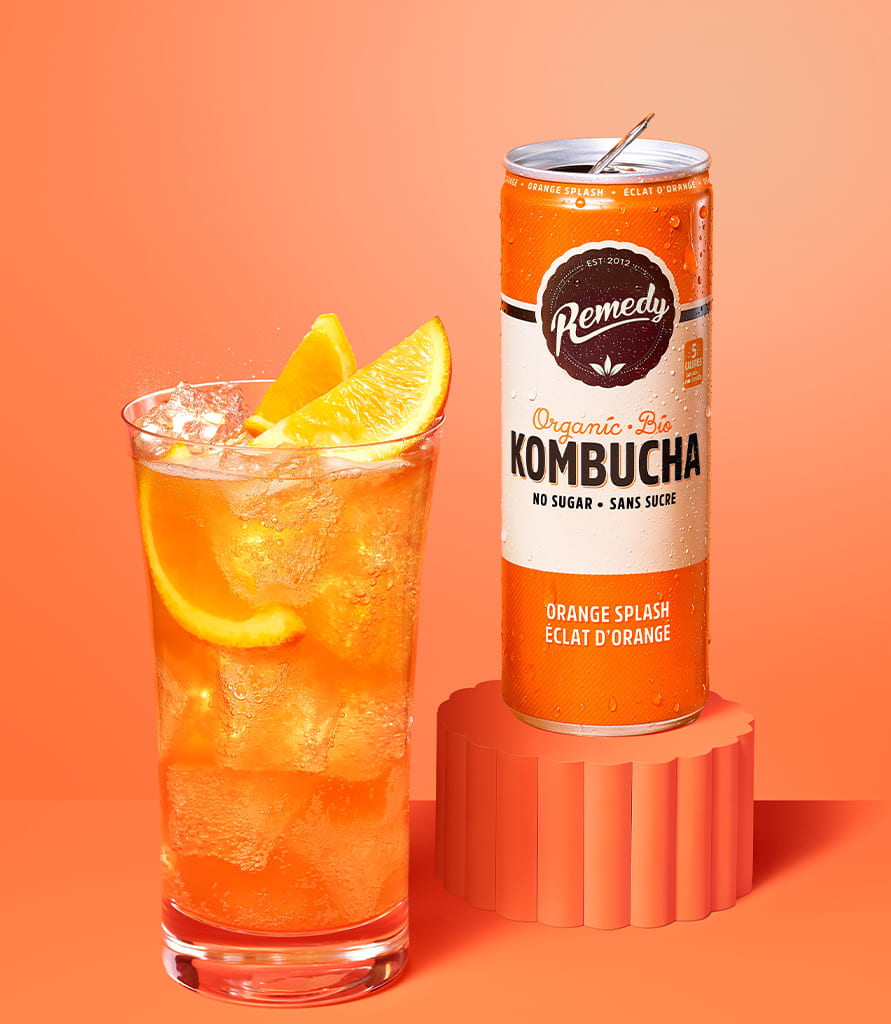 Remedy Orange Splash Kombucha Can with Glass full of Kombucha