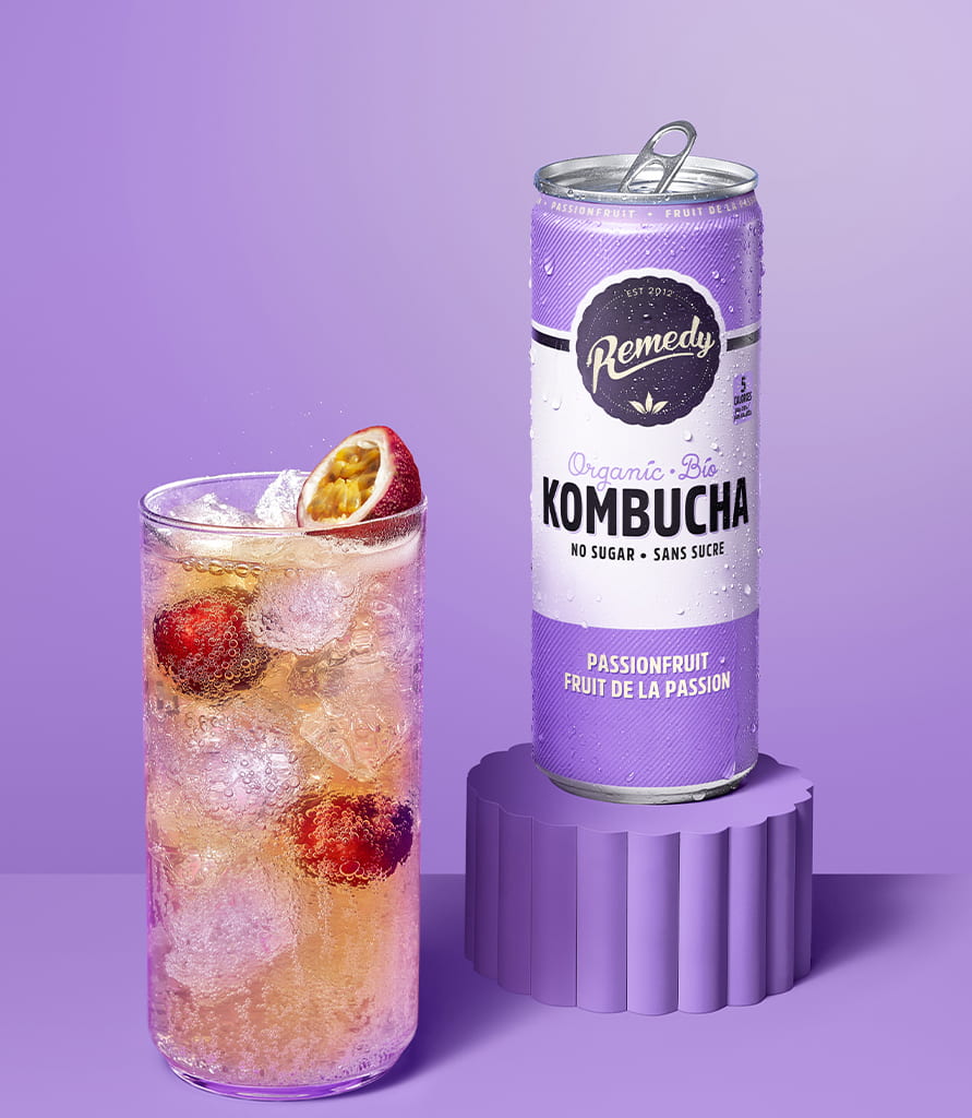 Remedy Passionfruit Kombucha Can with Glass full of Kombucha Lifestyle